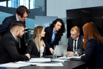 Business people discussing progress at meeting in office