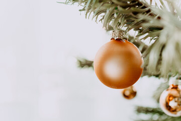Christmas golden ball on a Christmas tree branch. The concept of a village Christmas. Background postcard. a bright day. horizontal image