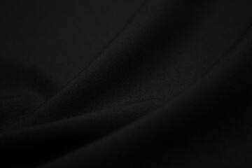 Texture of dark black fabric closeup. Low key photo. Plexus threads. Clothing industry. Abstract...
