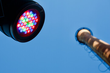 colorful led spotlights shine in front of industrial building - 543643585
