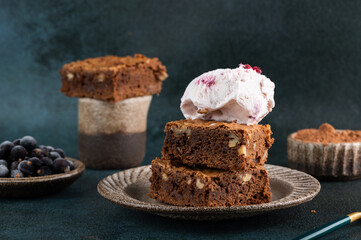 Chocolate brownies with ice cream. Chocolate dessert with nuts and ice cream. Chocolate fudge