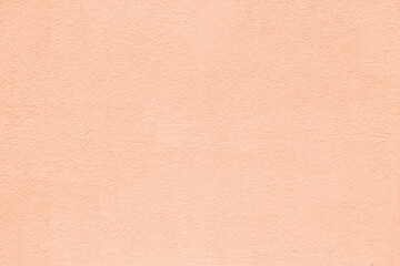 Pastel peach orange color old textured plaster background. Light rough wall texture