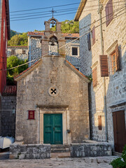 Fototapeta na wymiar Church of St. John the Baptist, from 16th century, in Perast, a charming village in Kotor Bay. Montenegro, Europe