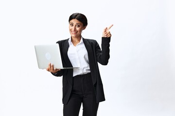 Business woman with laptop in hand in black business suit shows signals gestures and emotions on white background, freelancer job online training