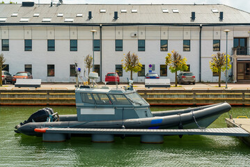 Police and border guard boat moored in dock.