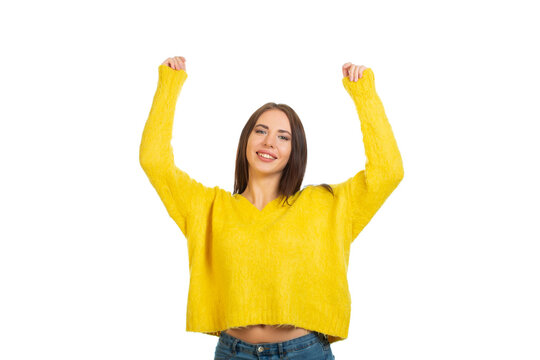Young smiling girl in a yellow sweater, Isolated on a white background.
