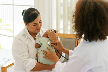 A newborn baby boy one-month-old mixed-race African-Thai,  visiting the doctor for checkup health with stethoscope at the clinic pediatric. concept consultation, check-up, nurse, healing infant.