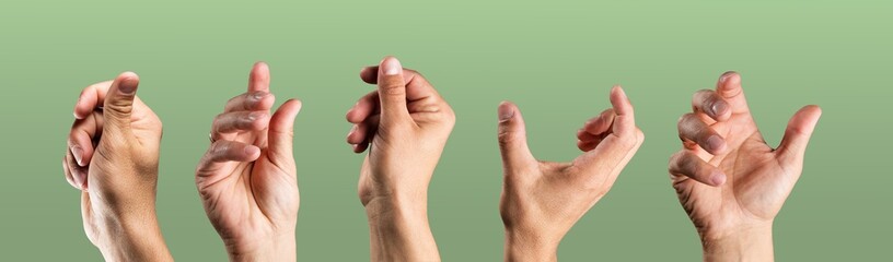 Man's hands on green background.