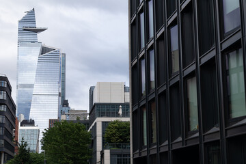 Obraz premium Modern Glass Skyscrapers and Buildings with a Gray Sky in Chelsea and Hudson Yards of New York City