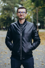 Obraz premium a man with glasses in a leather jacket