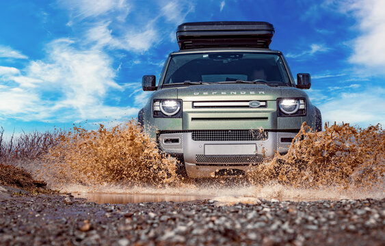Rybachy, RUSSIA - May 30 2022: Off-roading New Land Rover Defender. The Land Rover Defender is a series of British off-road cars and pick-up trucks.