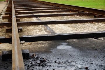 selective focus of ancient railroad tracks on cement concrete 