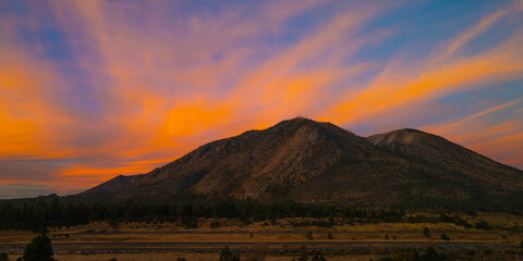 Sunrise over Eden Mountain Lookout Tower in Flagstaff, Arizona, USA, dramatic twilight cloudscape over the snow-covered mountains