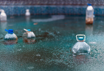 plastic bottles in frozen pool