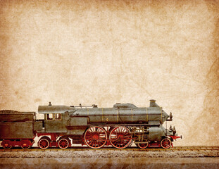 Antique model of old train locomotive isolated on old antique vintage paper background
