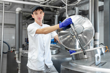 Automated milk production process at the factory. Worker on a milk factory.