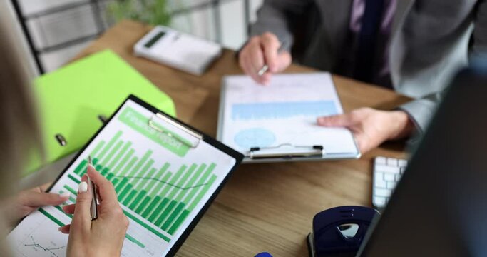 Business people at the table are discussing a financial report