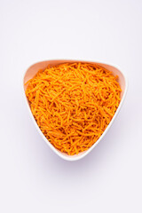 Tomato sev is a crispy crunchy orange colored flavored fried farsan with salt and spice powders