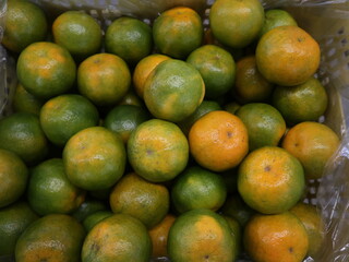 food background of colorful and fresh tangerinrs design for seasonal concept