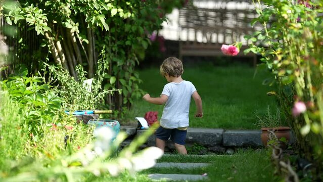 One Candid Little Boy Exploring House Backyard Garden