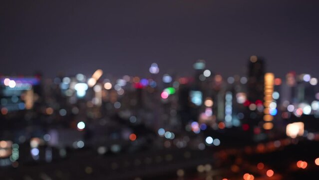 night cityscape view with skyscrapers lights bokeh defocused background. Bokeh blurred traffic on highway road at night. horizontal 4k height resolutions 2160 x 3840