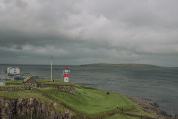 Fototapeta na wymiar Lighthouse of Torshavn in the Faroe Islands overlooking the Atlantic Ocean