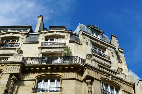 Paris, France - A view of the facade of a typical Haussmann style building as seen from below.  Image has copy space.