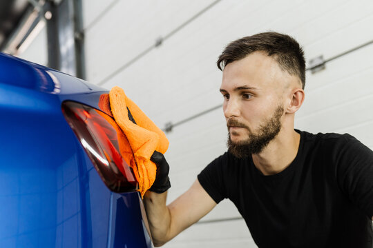 Cleaner Man Worker Dry Body Car After Washing Automobile. Hand Car Drying With Microfiber In Detailing Auto Service.