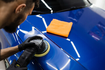 Abrasive paste car polishing with orbital polisher for remove scratches. Worker of detailing auto...