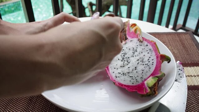 Female hands holding fresh ripe organic dragon fruit or pitaya.