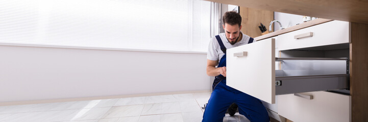 Handyman Installing Drawer