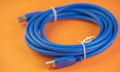 USB connection cable on orange background