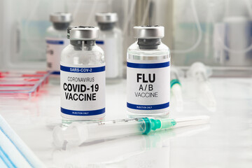 Coronavirus vaccine bottles and Flu Shot vaccine for booster vaccination for new variants of...