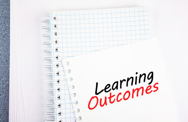 Learning Outcomes - quote text on paper. The concept of success in learning, taking courses.
