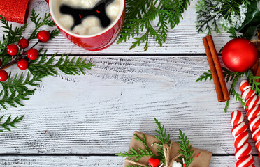 Christmas card with toys, fir branches and a garland.Decor with sweets, cinnamon.