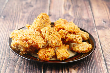 Crispy fried chicken wings on a plate top view .