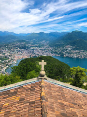 The Church of San Salvatore with its lookout point offering stunning panoramic views of Lake Lugano, the city of Lugano and the magnificent mountain ranges of the Swiss and Savoy Alps, Switzerland.
