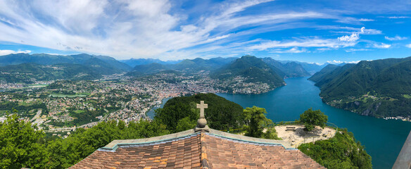 The Church of San Salvatore with its lookout point offering stunning panoramic views of Lake Lugano, the city of Lugano and the magnificent mountain ranges of the Swiss and Savoy Alps, Switzerland.