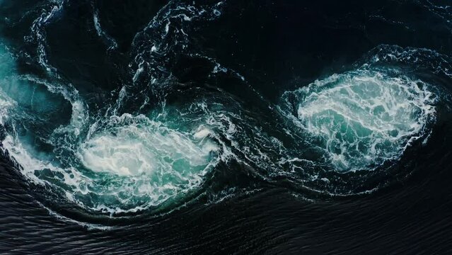 Waves of water of the river and the sea meet each other during high tide and low tide. Deep blue stormy sea water surface with white foam and waves pattern, background texture