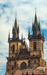 Fototapeta na wymiar Double towers of Church of Our Lady before Tyn in Old Town ,Prague, Czech Republic. Looking up with blue sky and white clouds beyond..