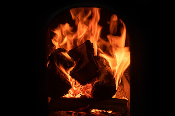 A fire burns in a fireplace. Fire to keep warm.