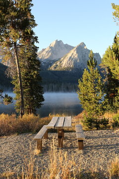 Picnic table with lake and mountain in the background