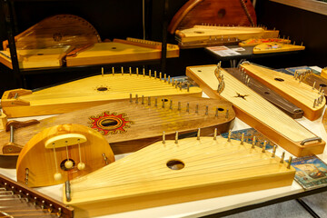 Vintage musical instruments dombra gusli balalaika wooden patterns on the table.