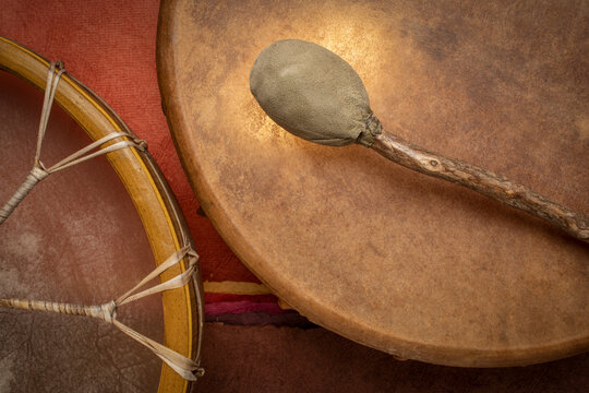 two handmade, native American style, shaman frame drums covered by goat skin with a beater