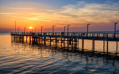 Fototapeta premium Sunset over the pier in Pomorie
