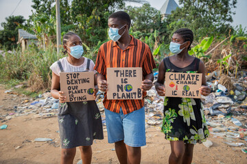 African youth protesting against climate change holding signs and wearing masks