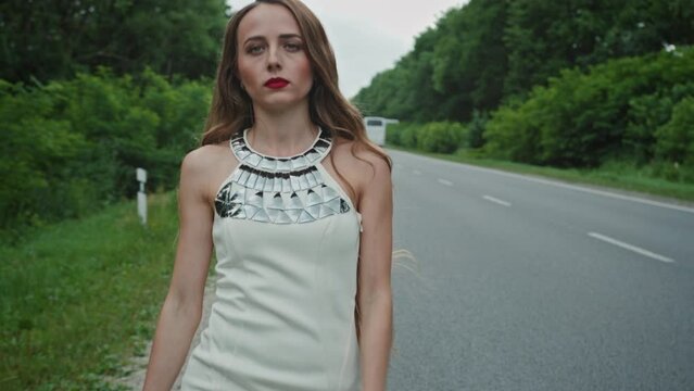 Tracking shot of prostitute walking near road