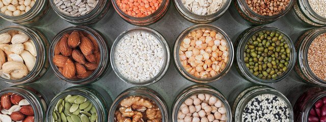Vegan source of protein. healthy vegetarian food. top view of seeds, nuts, peas, beans, spelt, oatmeal on white background banner