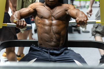 Fitness Workout: Boy doing Exercises in Class with Gym Equipment for Pectoral Muscles