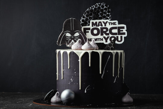 Kyiv, Ukraine - October 11: Star Wars cake with black cream cheese frosting and white chocolate drips decorated with edible  Darth Vader head silhouette and "May the force be with you" text